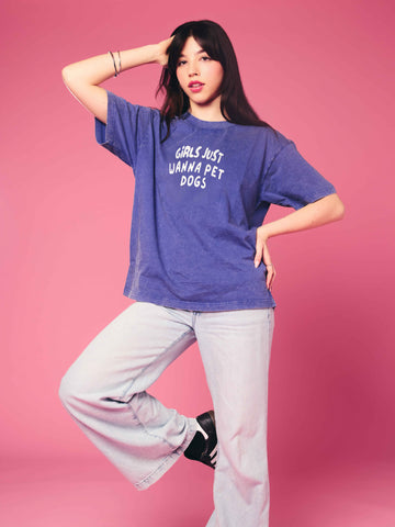 Person wearing a blue t-shirt with text on a pink background