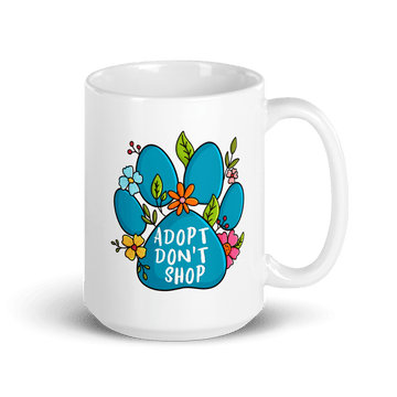 White mug with a blue paw print design and 'Adopt Don't Shop' text on a white background