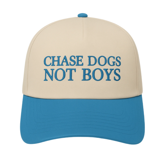 Beige and blue cap with 'CHASE DOGS NOT BOYS' text on a white background