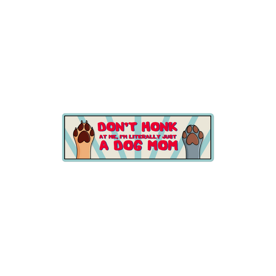 Bumper sticker with dog paws and text 'Don't honk at me, I'm literally just a dog mom' on a white background
