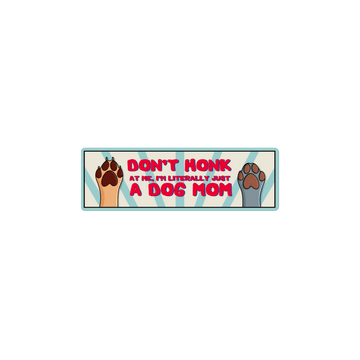 Bumper sticker with dog paws and text 'Don't honk at me, I'm literally just a dog mom' on a white background