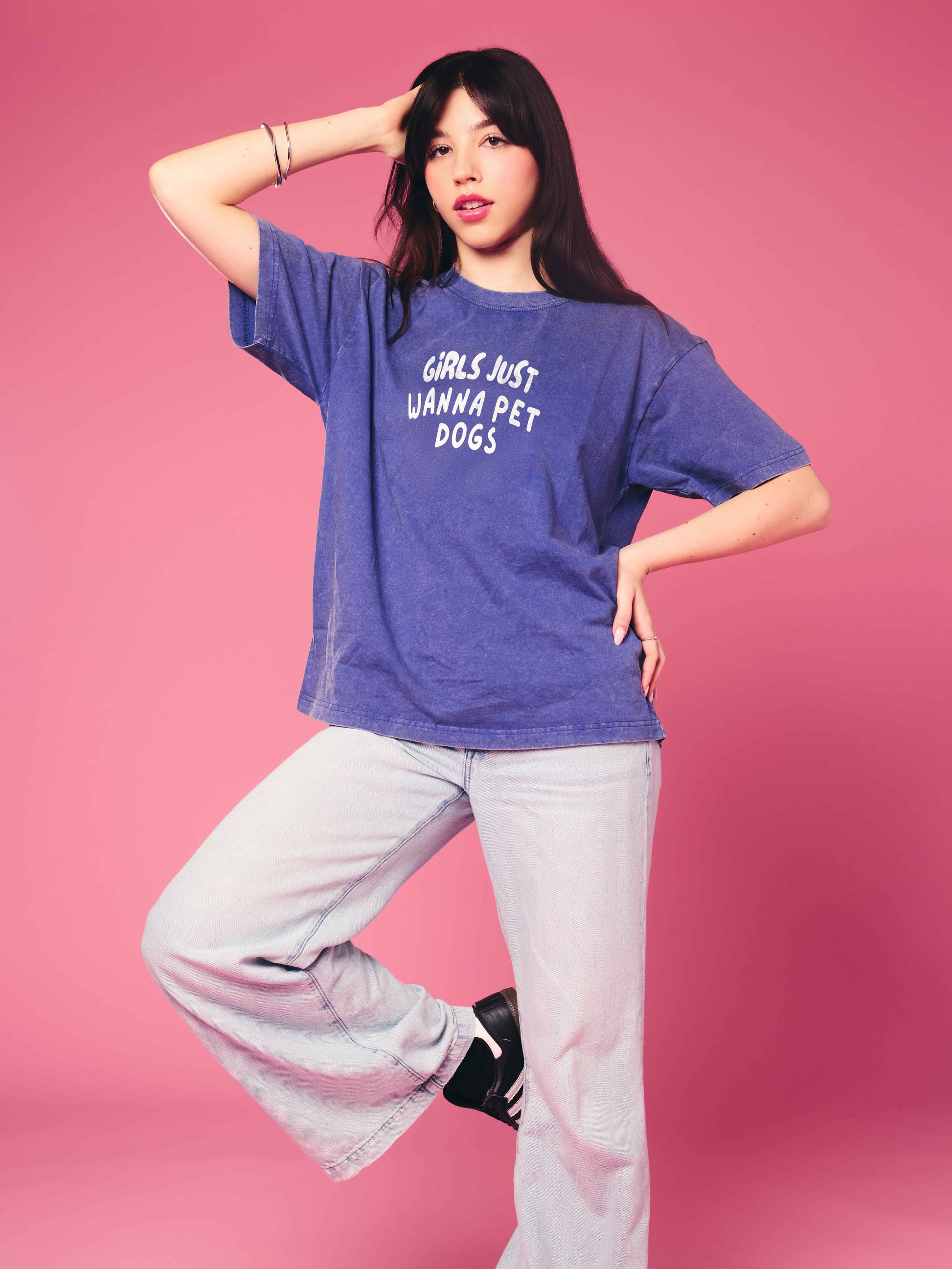 Person wearing a blue t-shirt with text on a pink background